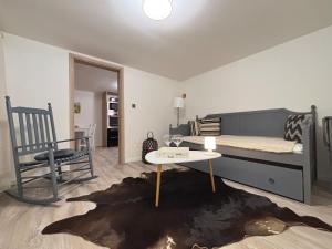 a bedroom with a bed and a table and a chair at Dom na Záhumní in Krpeľany