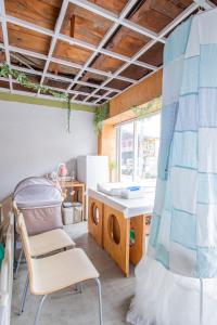 a kitchen with a table and a chair in a room at 一棟貸し切り宿 Hojo Machi Hostel in Kasai
