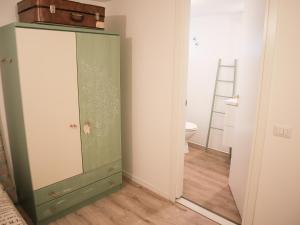 a bathroom with a green cabinet and a toilet at Room Sweet Room  +1 photo