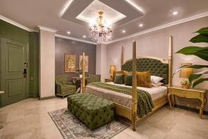 a bedroom with a bed and a chair and a chandelier at Hotel Osvé Boutique Cali in Cali +41 photos