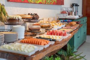 a buffet with many different types of food on a table at Graciosa Suites in Praia do Frances