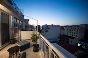 a balcony with a view of a city with buildings at Piraeus Harbor Hideaway in Piraeus