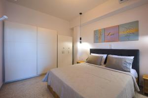 a bedroom with a large bed with two pillows at Piraeus Harbor Hideaway in Piraeus