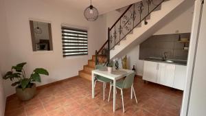 a kitchen with a table and chairs and a staircase at Estudio las lajas in Chío