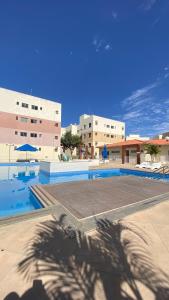 a shadow of a person standing next to a swimming pool at Residencial Mais Viver São Francisco in Petrolina