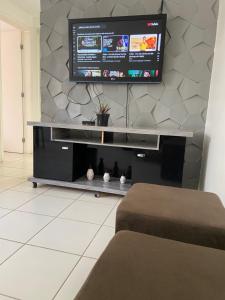 a living room with a flat screen tv on a wall at Residencial Mais Viver São Francisco in Petrolina