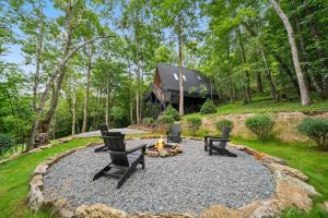 a fire pit in a yard with chairs and a house at Alpine A-Frame at Calm Ridge Treehouses in Boone