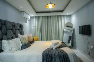 a bedroom with a large bed and a mirror at Unit 5 and 6 Homely Escapes in Phalaborwa