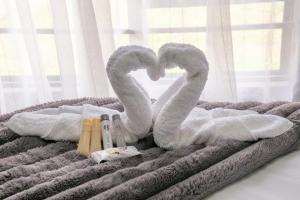 a bed with two swans shaped towels on it at Unit 5 and 6 Homely Escapes in Phalaborwa