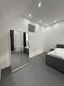 a bedroom with a bed and a mirror at Beethoven Suite in Vienna