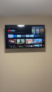 a flat screen tv hanging on a wall at O'Briens Luxury Studio City Centre in Galway