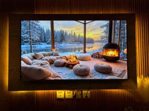 a television with a picture of a living room with a fireplace at Gold Crest Luxury Hotel Apartments-City View DHA Lahore in Lahore