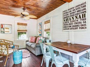 a living room with a table and a couch at Blue Cat in Tybee Island