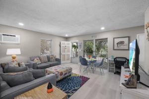a living room with a couch and a table at Peaceful condo with pool and steps to beach in Marco Island