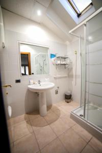 a bathroom with a sink and a shower at Residence Hotel Azzurro in LʼAquila