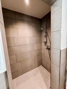a bathroom with a shower with a shower head at P&S Home in Nordstemmen