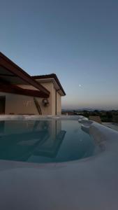 a large swimming pool on top of a house at Esperidi Paestum Agri Resort in Capaccio-Paestum