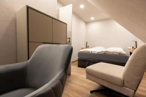 a bedroom with a couch and a chair and a bed at Red Kite Resort in Ribnitz-Damgarten