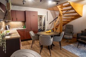 a kitchen and dining room with a table and chairs at Red Kite Resort in Ribnitz-Damgarten