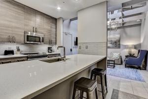 a kitchen with a sink and a counter with stools at Parker's Collection Unit 8 in Savannah