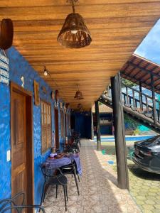 a patio with tables and chairs under a building at Pousada Figueira in Trindade