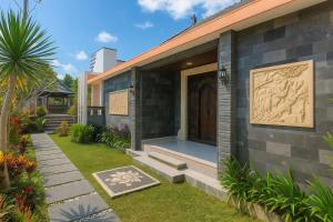 a house with a front door and a garden at Shitala Villa in Munduk