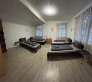 a large room with three beds in it at PaNi2 in Altdorf bei Nuernberg
