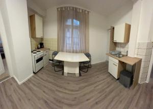 a small kitchen with a white table and a stove at PaNi2 in Altdorf bei Nuernberg +1 photo