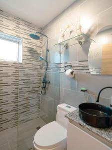 a bathroom with a toilet and a sink at Luxury Villa in Vista Cana with Private Pool and BBQ in Punta Cana