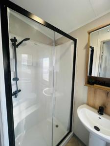 a bathroom with a glass shower and a sink at Haven Berwick in Berwick-Upon-Tweed