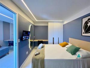 a bedroom with a bed and a tv on the wall at Aquarius Style by Holiday Stays in Fortaleza