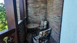 a small table and two chairs on a balcony at Metekhi Line By OldTown in Tbilisi City