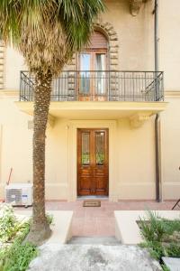 a house with a wooden door and a balcony at Canto dei Mille in Florence