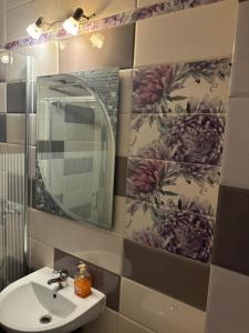 a bathroom with a sink and a mirror at Central Elegant Lofts in Piatra Neamţ