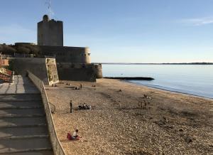 a group of people on a beach near the water at Chez Christine et Jean-Louis in Fouras