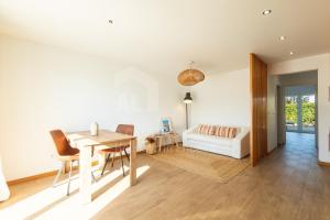 a living room with a table and a couch at Valentin House by ACasaDasCasas in Santo Isidoro +11 photos