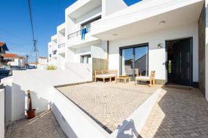a white house with a patio in front of it at Valentin House by ACasaDasCasas in Santo Isidoro