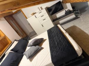 a bedroom with a large bed and a flat screen tv at Stone Nest Lanzada in Lanzada +7 photos