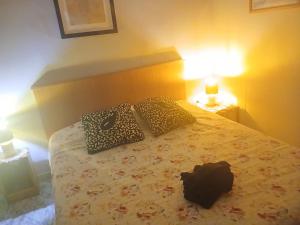 a bedroom with a bed with two pillows and a bag on it at Dream of Eden in Rome