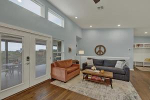 a living room with a couch and a table at Esperanza Ranch w/Hot-tub, Fire pit, Gorgeous View in Stonewall