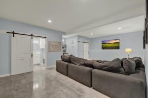 a living room with a large couch and a kitchen at Esperanza Ranch w/Hot-tub, Fire pit, Gorgeous View in Stonewall