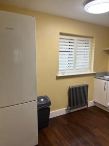 a kitchen with a refrigerator and a window at Boycott House in Shalstone +5 photos