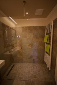 a bathroom with a shower with a sink at Gasthof Schorn in Sankt Leonhard