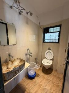 a bathroom with a tub and a toilet and a sink at S&K villa 3 BHK PRIVATE POOL in Lonavala