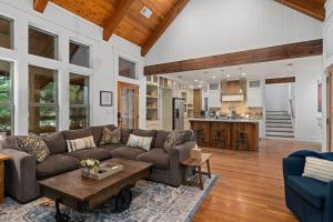 a living room with a couch and a table at Life is Gruene-Riverfront Luxury-1Mi To GrueneHall in Gruene