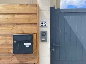 a wooden gate with a door and a sign on it at Studio Castéra 1 Air-conditioned in Bègles
