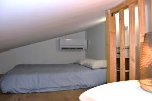 a bedroom with a bed in a attic at Studio Castéra 1 Air-conditioned in Bègles
