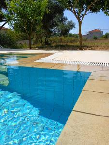 a swimming pool with blue water at Sti Physi in Keramiaí +39 photos