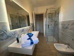 a bathroom with two sinks and a shower at Domu Jole B&B in Selargius +45 photos