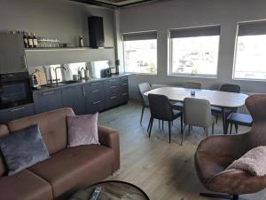 a living room with a couch and a table and chairs at LL Properties - TB24 The Boutique Flat in Akureyri